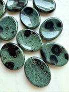Kambaba Jasper worry stones with deep green, dusky teal, and black orbicular patterns, polished grounding crystals for calm