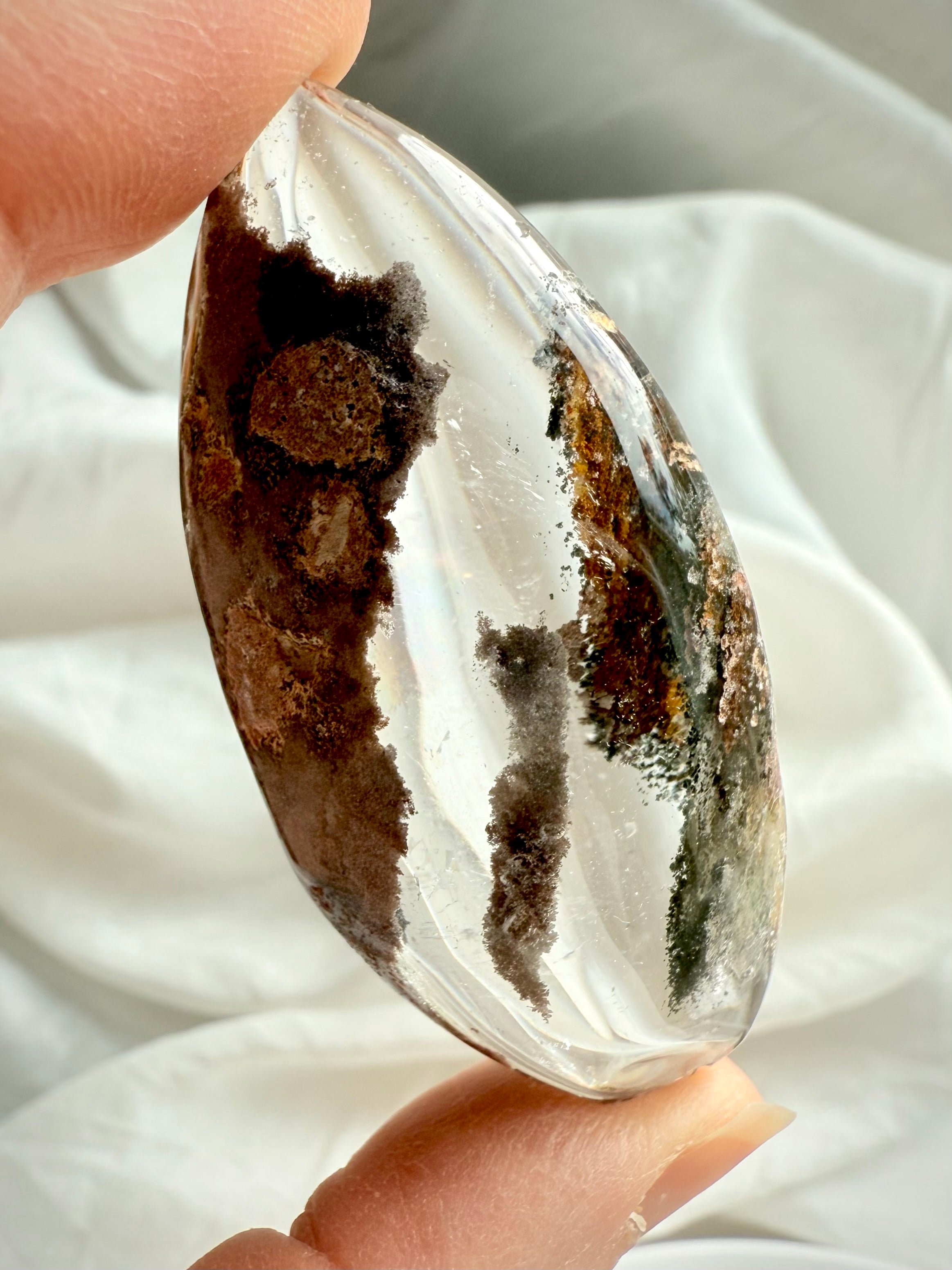 Back view of Garden Quartz lens with natural inclusions, texture, and polished edges