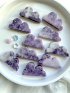Assorted Lepidolite cloud crystal carvings in soft lavender tones with natural mottling and unique patterns