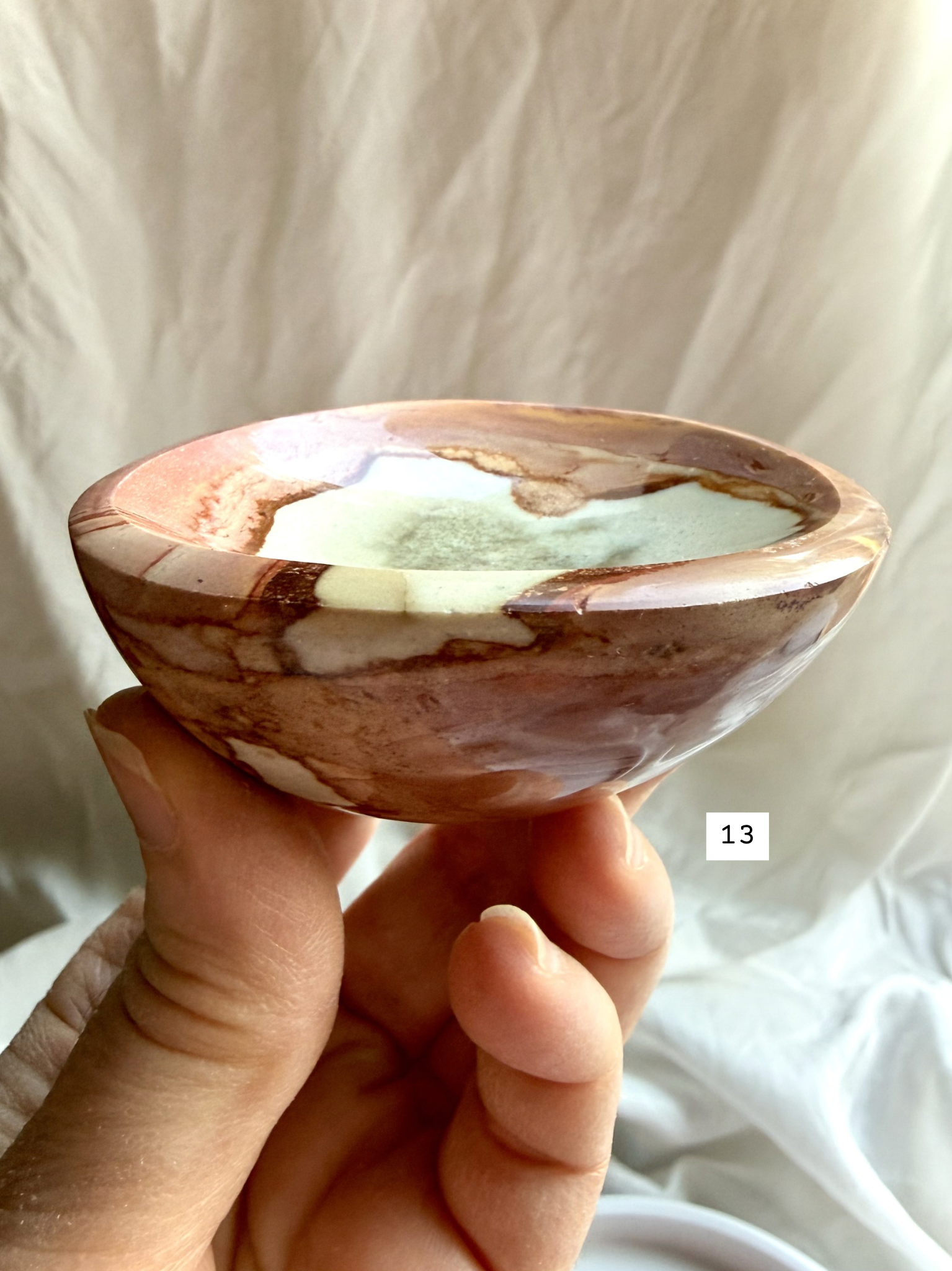 polychrome jasper crystal bowl held in hand side view natural stone dish showing depth and polished edge