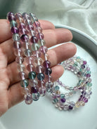 Fluorite bead bracelet shown on hand featuring polished translucent gemstones for focus & intuition