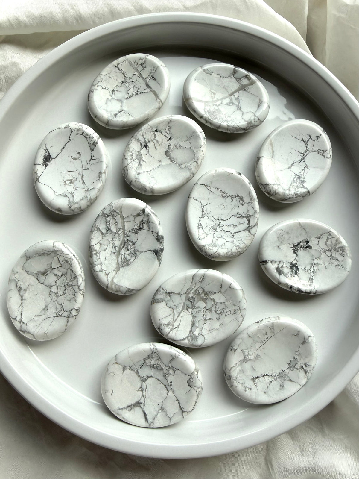 White Howlite worry stones with natural gray matrix patterns and smooth polished finish for meditation and peaceful reflection