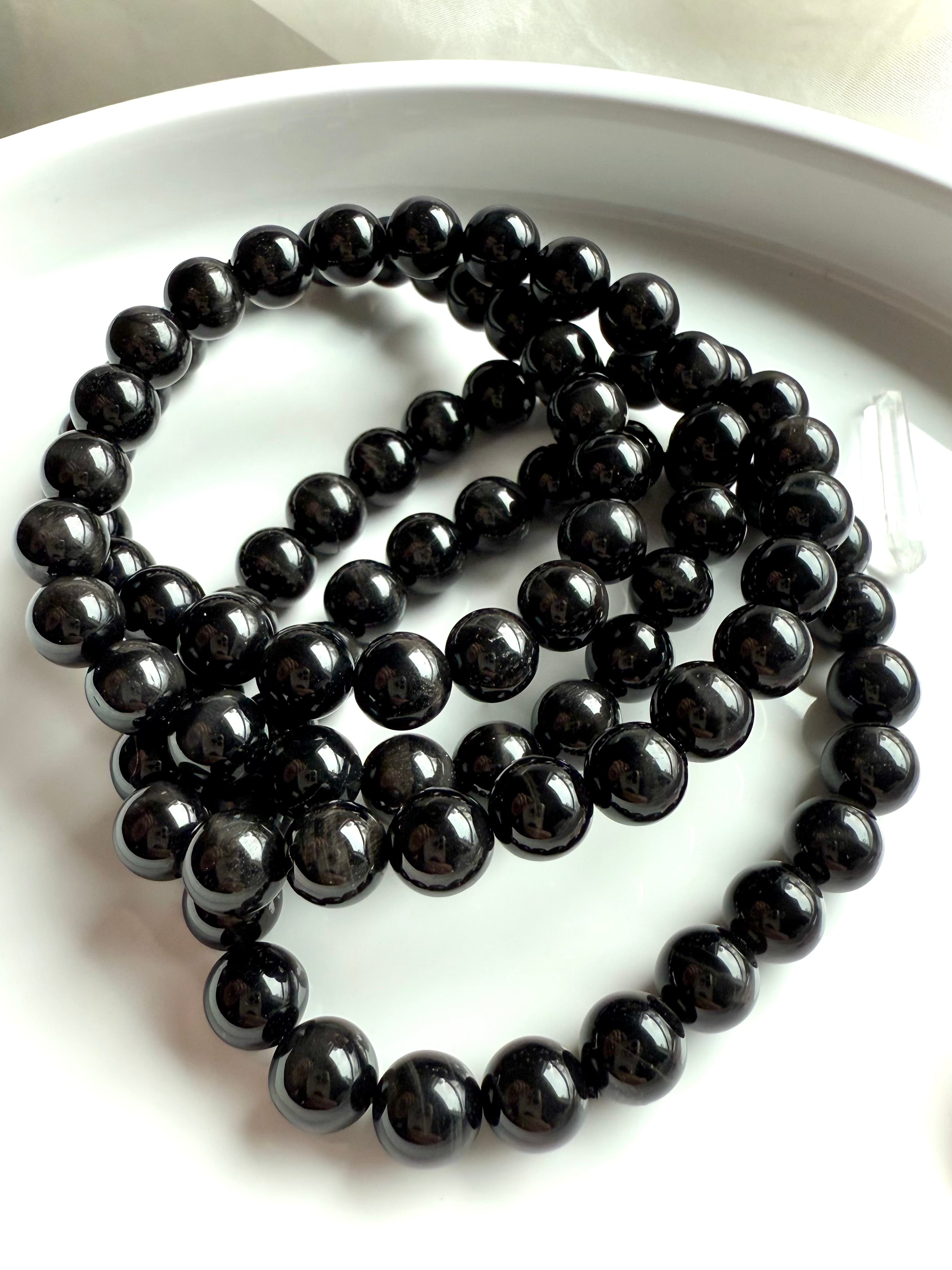 Black Tigers Eye Bracelet made from glossy black beads with tiger eye striations + cat’s eye shimmer