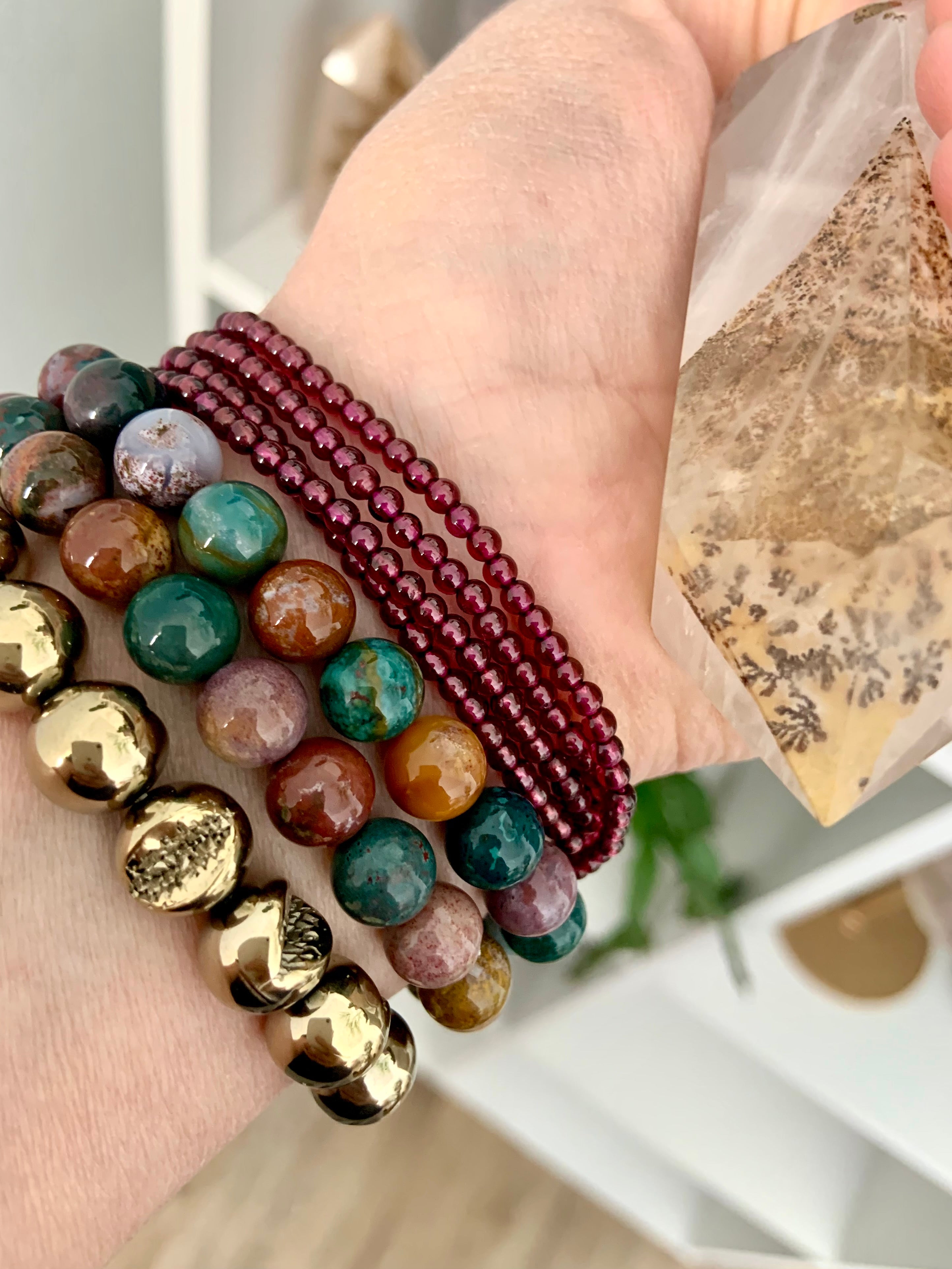 Pyrite bracelet worn with Ocean Jasper & Garnet bracelets — crystal stack for grounding, emotional balance & abundant energy.