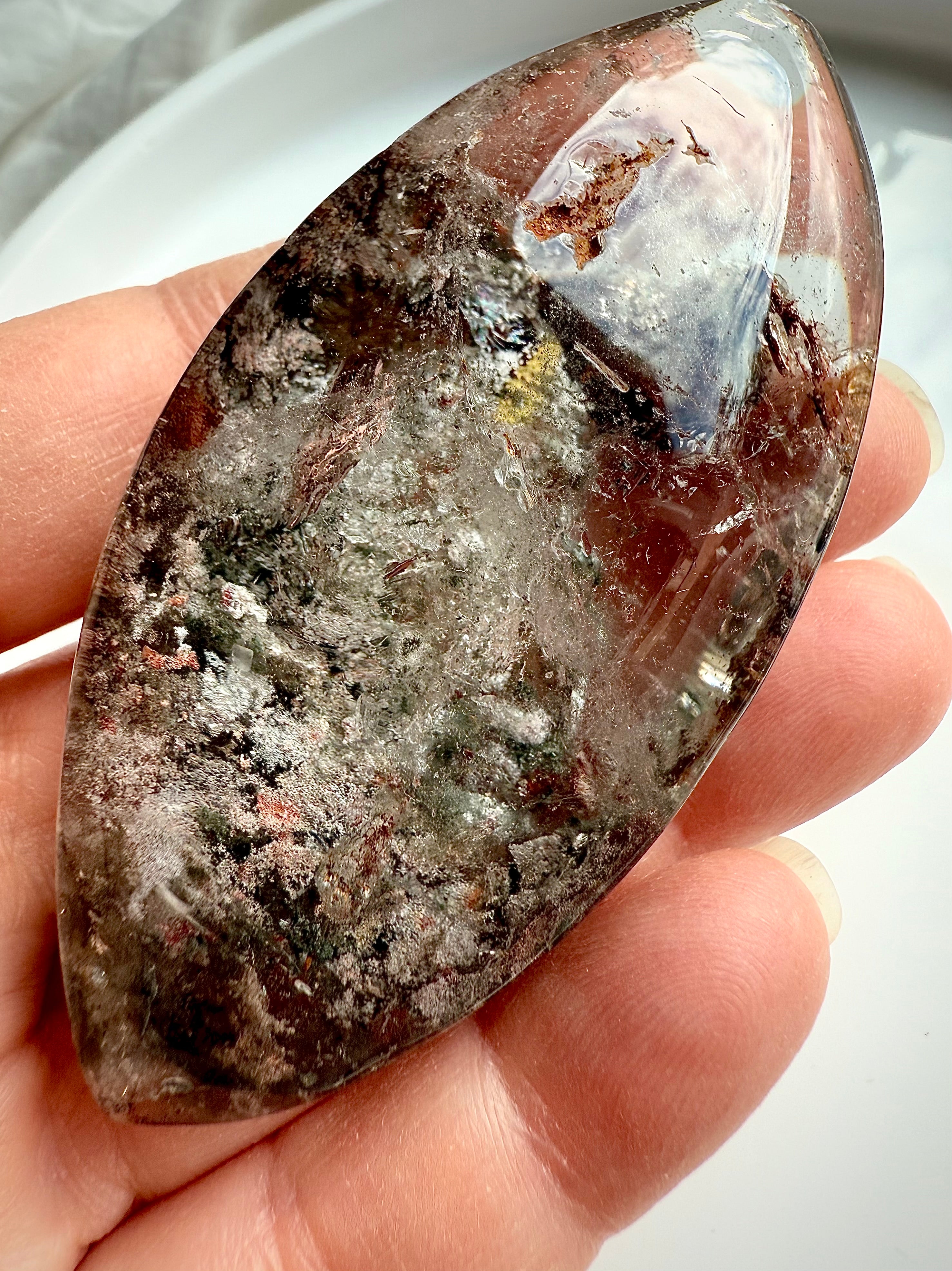 Scenic lodolite crystal inside Garden Quartz marquise with earthy mineral textures and light play