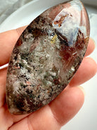 Scenic lodolite crystal inside Garden Quartz marquise with earthy mineral textures and light play
