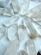 Chunky Lemurian Quartz points from Brazil with natural ladder lines, cloudy inclusions, and varied raw crystal formations