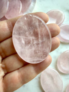 rose quartz palm stone held in hand for love compassion and emotional balance