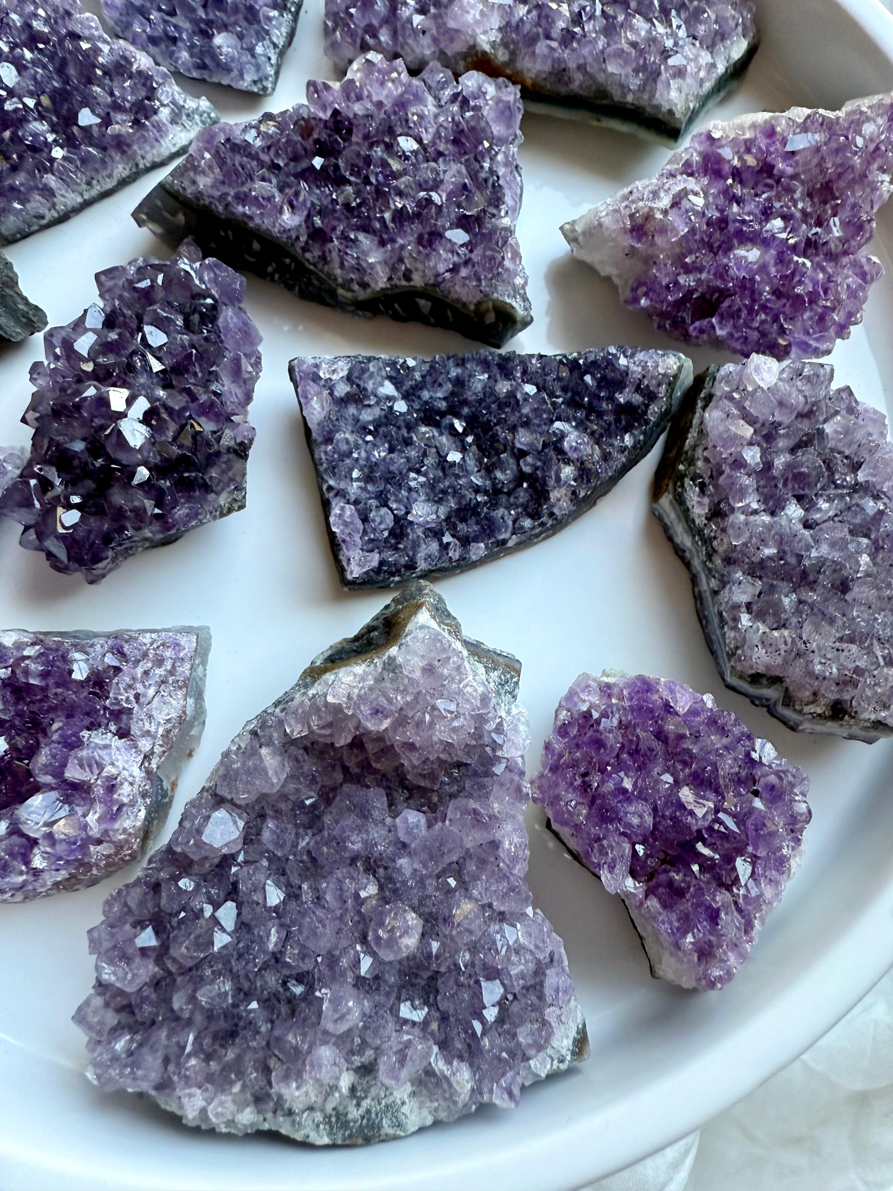 Closeup of small amethyst geode clusters with rich purple sparkle