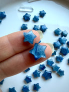 Mini Blue Kyanite crystal stars shown up close highlighting luminous sapphire and silvery blue tones