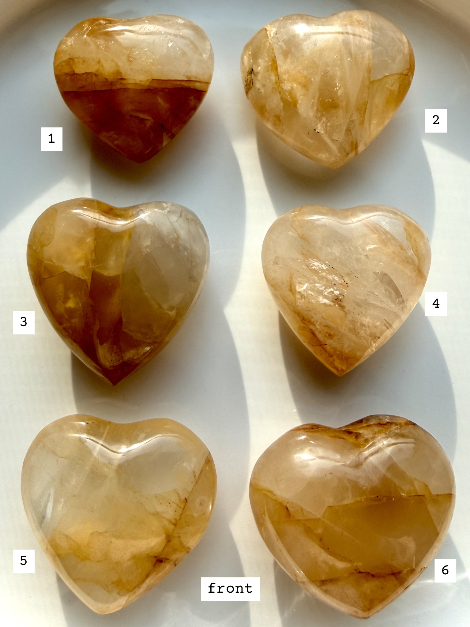 golden healer quartz hearts labeled 1–6 front view showing variation in golden tones clarity and natural inclusions