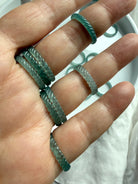 High-transparency Blue Water Jade woven band rings worn on hand, showing braided jadeite texture and luminous glow
