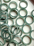 Full tray of rounded Blue Water jadeite band rings, natural jade crystal ring assortment