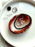 black spinel bracelet styled with carnelian crystal bowl for grounding protection and energy work