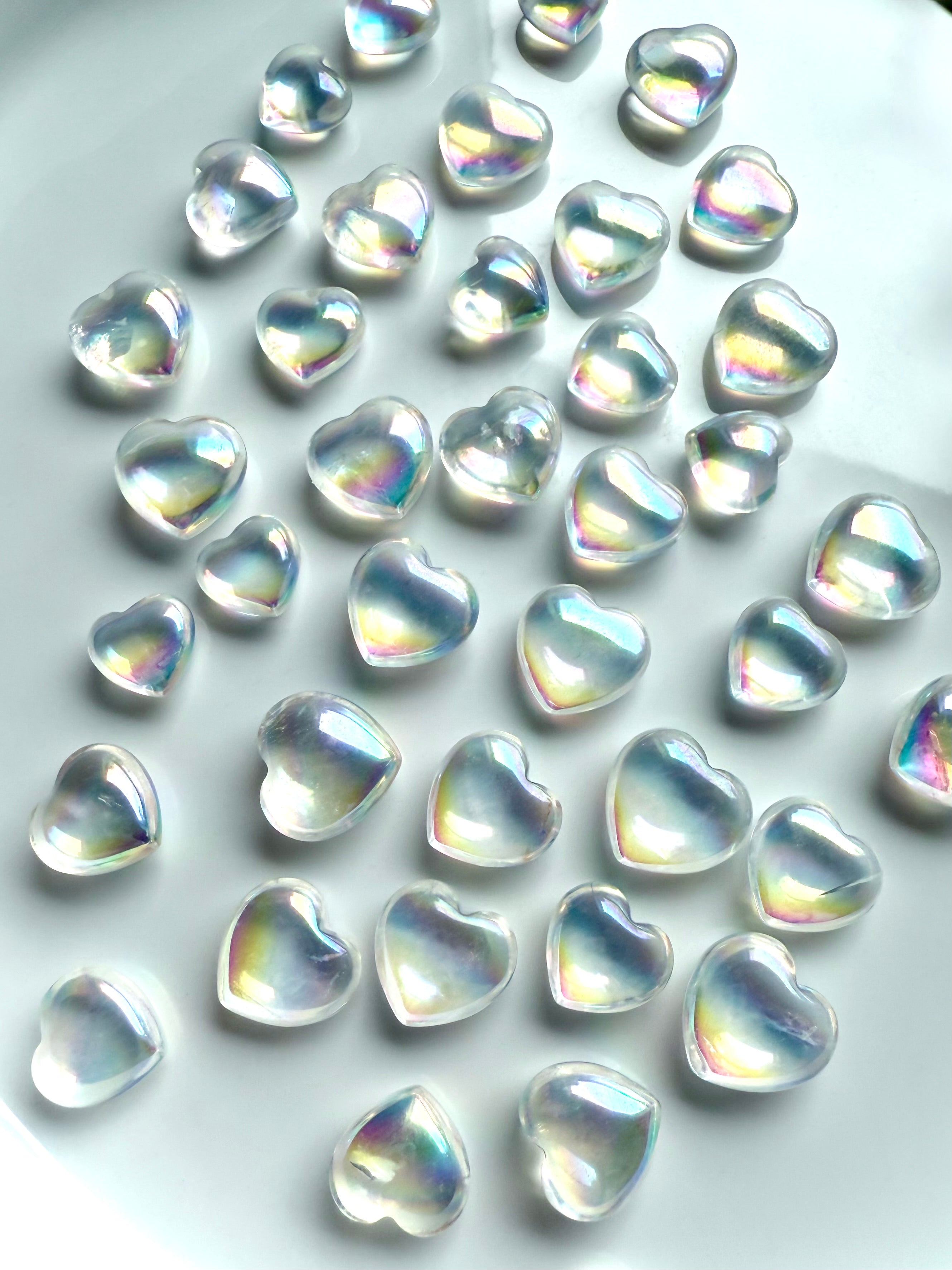 Opalescent aura quartz hearts glowing with iridescence, perfect for angelic energy and love rituals