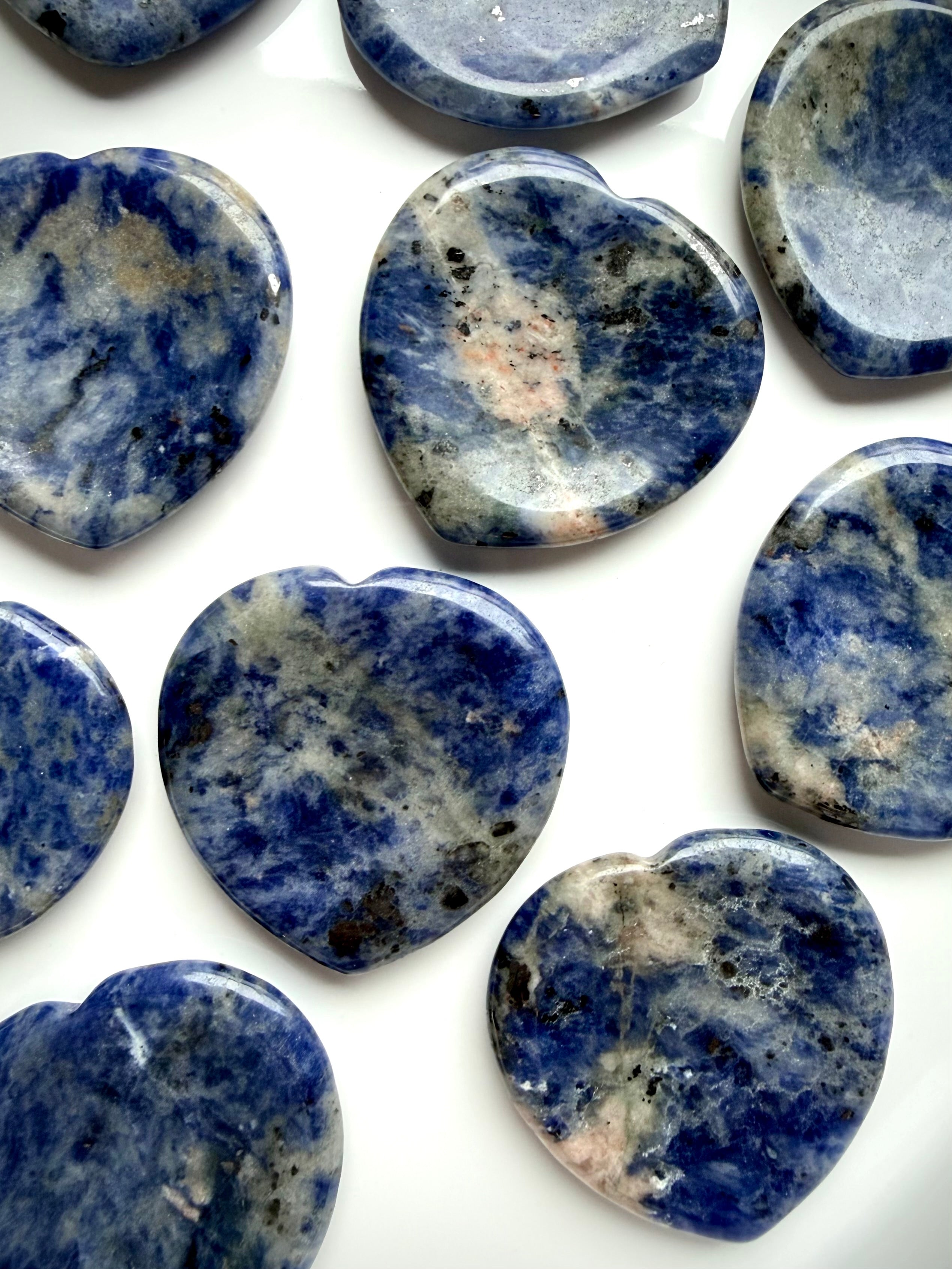 Closeup sodalite heart worry stones showing natural blue stone pattern and mineral inclusions