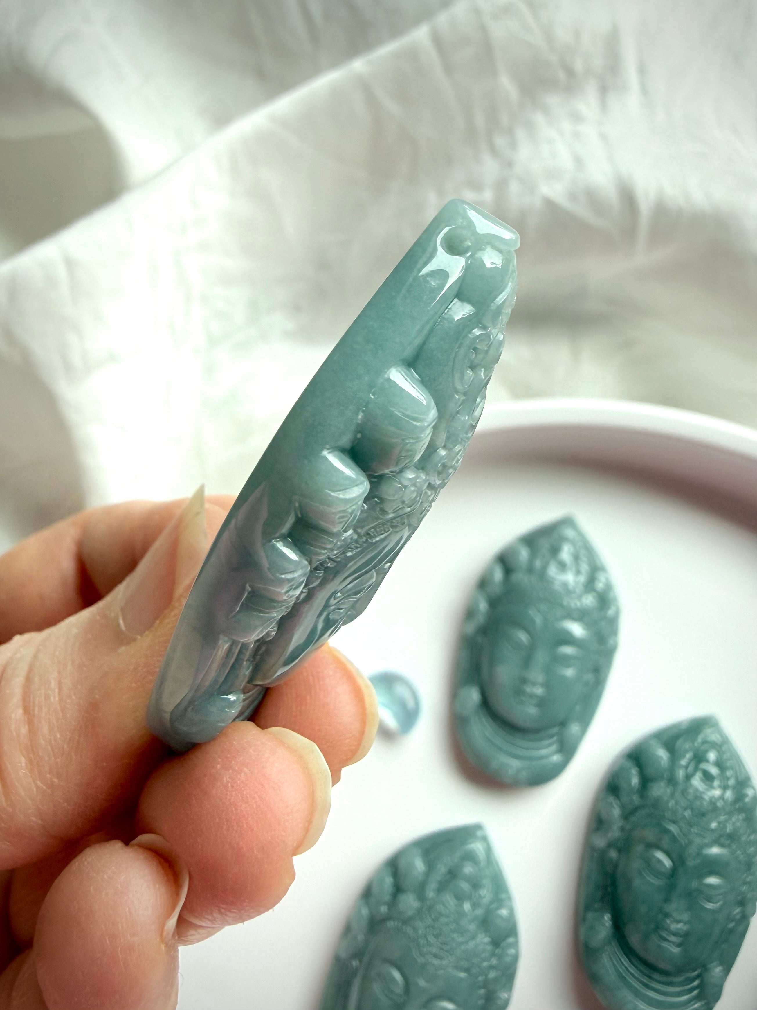 Blue Water Jade Quan Yin carving pendant side view showing thickness and polished finish