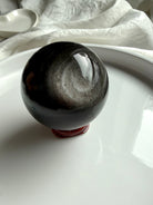 Silver Sheen Obsidian crystal sphere on stand — powerful altar stone for grounding, protection, and clarity