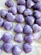 Closeup of Mini Lilac Lepidolite crystal hearts with soft lavender and violet tones