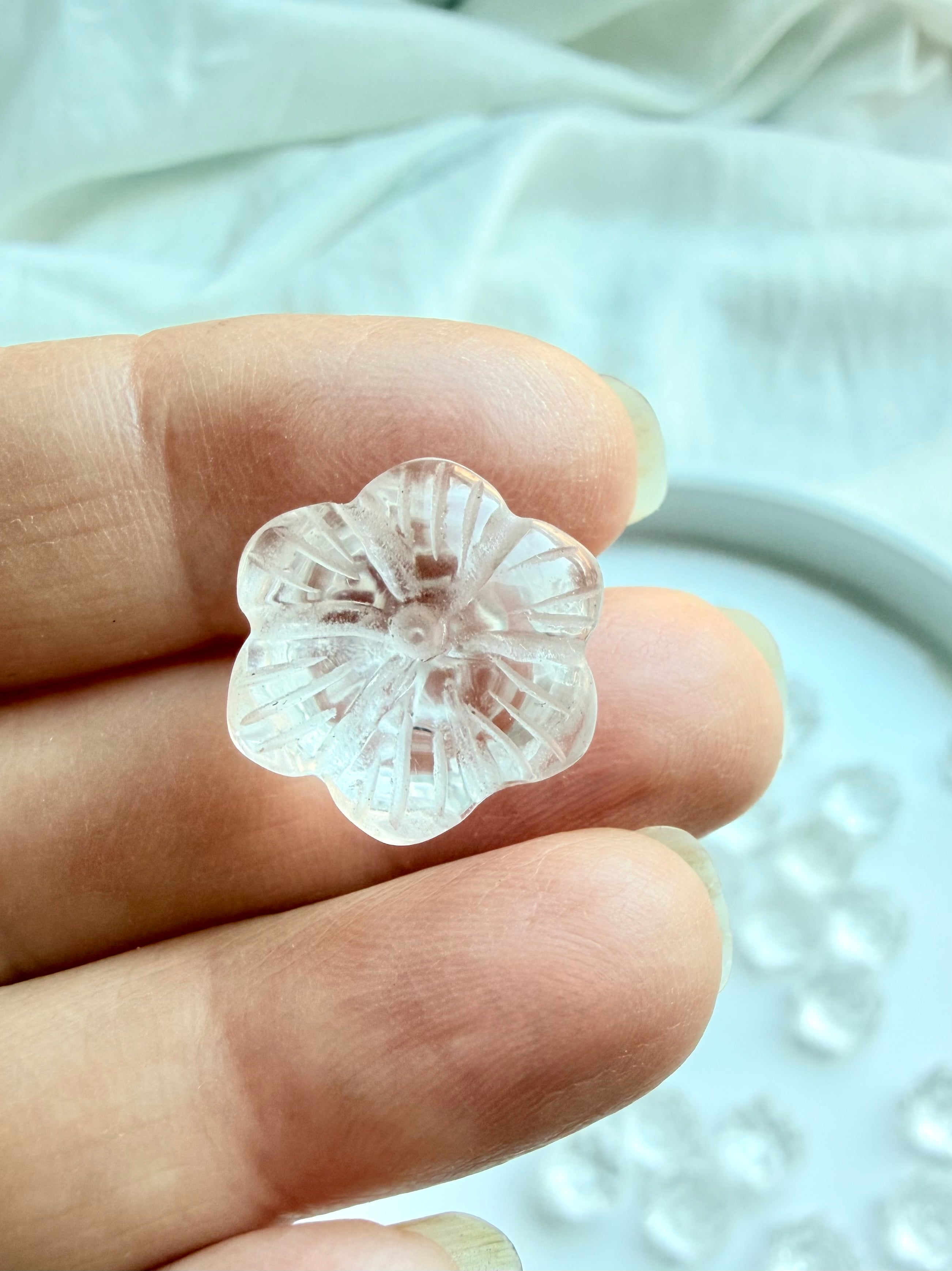 Mini Clear Quartz lotus crystal flower held in hand showing the underside detailed hand-carved petals and transparent quartz