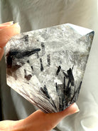 Large Black Tourmaline in Quartz freeform crystal for protection and energetic grounding, held in hand