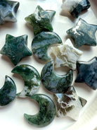 Close-up of Moss Agate moons and stars showing intricate moss-like inclusions and natural banding — heart chakra healing crystals for grounding and emotional renewal.