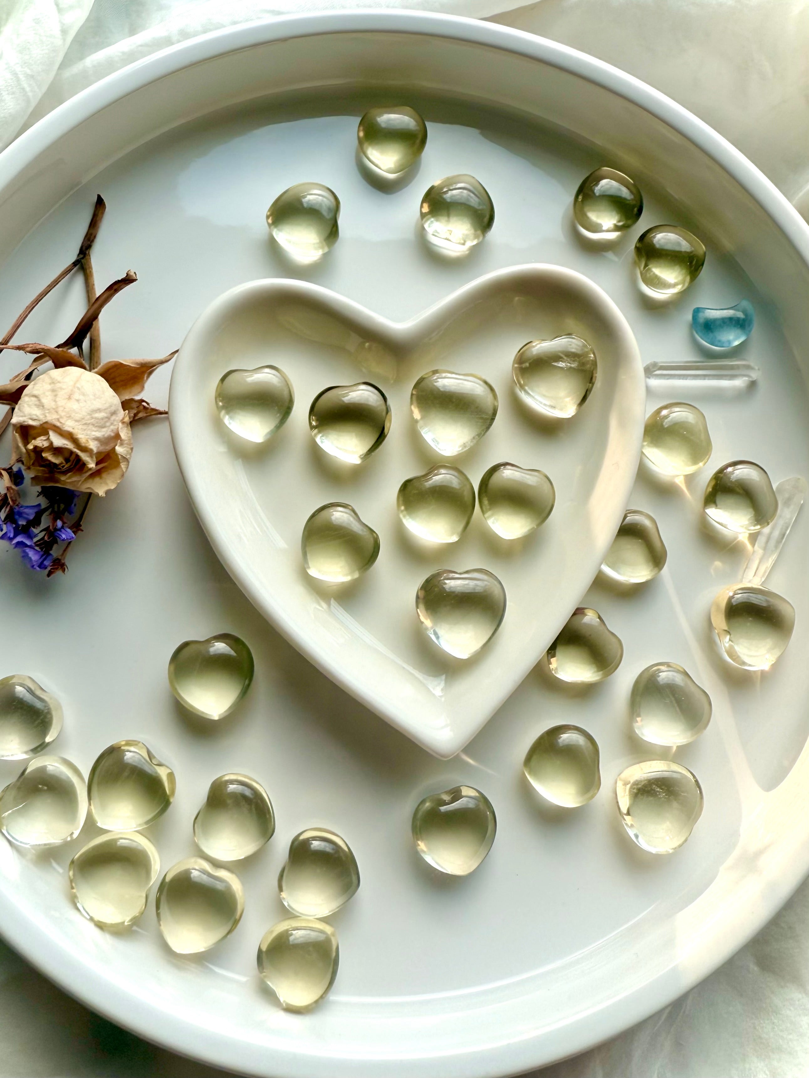 Mini Lemon Citrine heart crystals on white plate in a heart-shaped bowl, polished citrine gemstone shapes