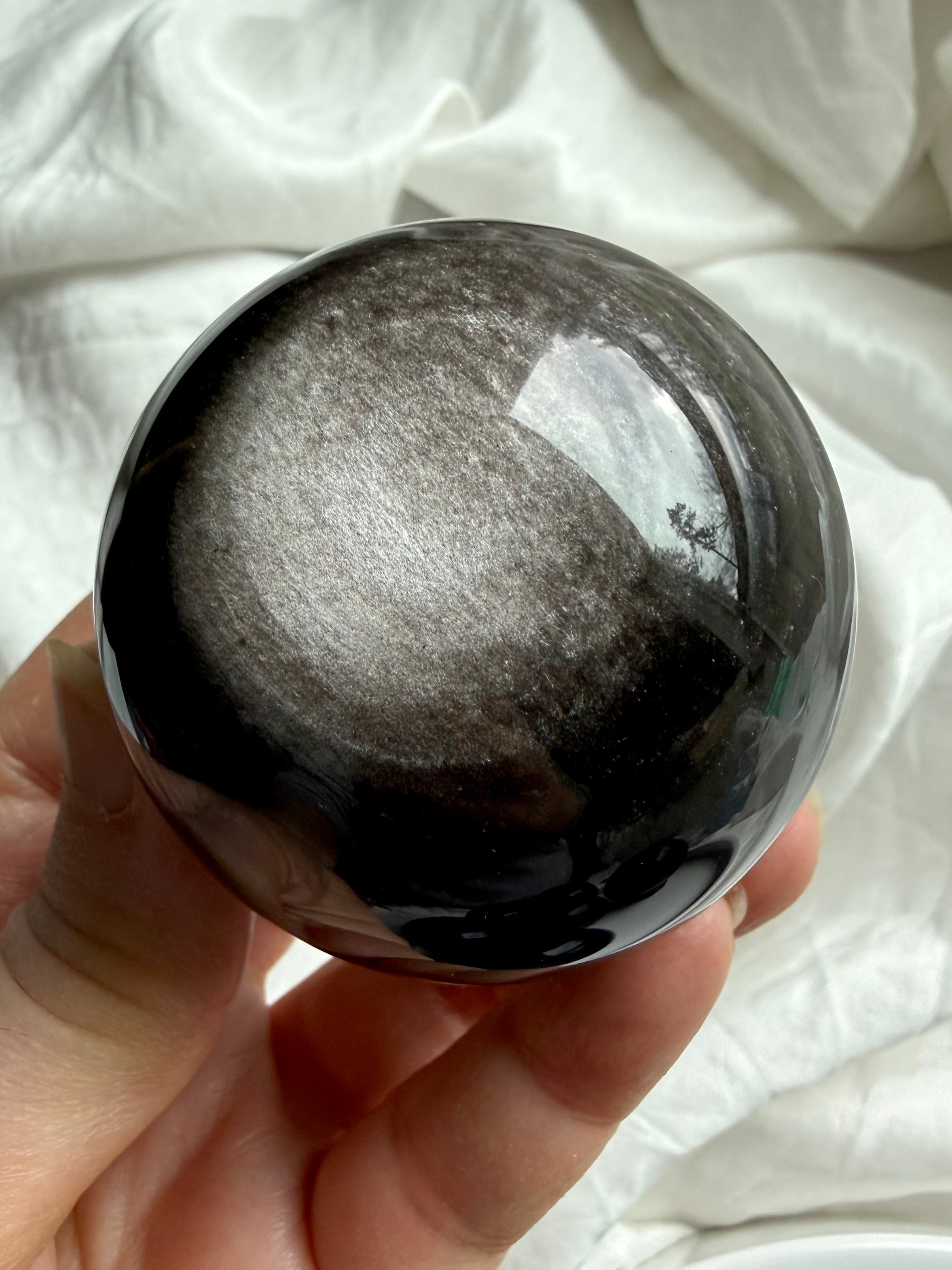 Hand-held Silver Sheen Obsidian sphere for meditation, shadow work, and intuitive crystal healing
