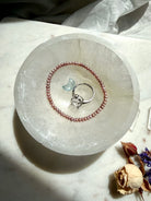 selenite jewelry bowl styled with ring and bracelet, crystal charging bowl for jewelry cleansing and display