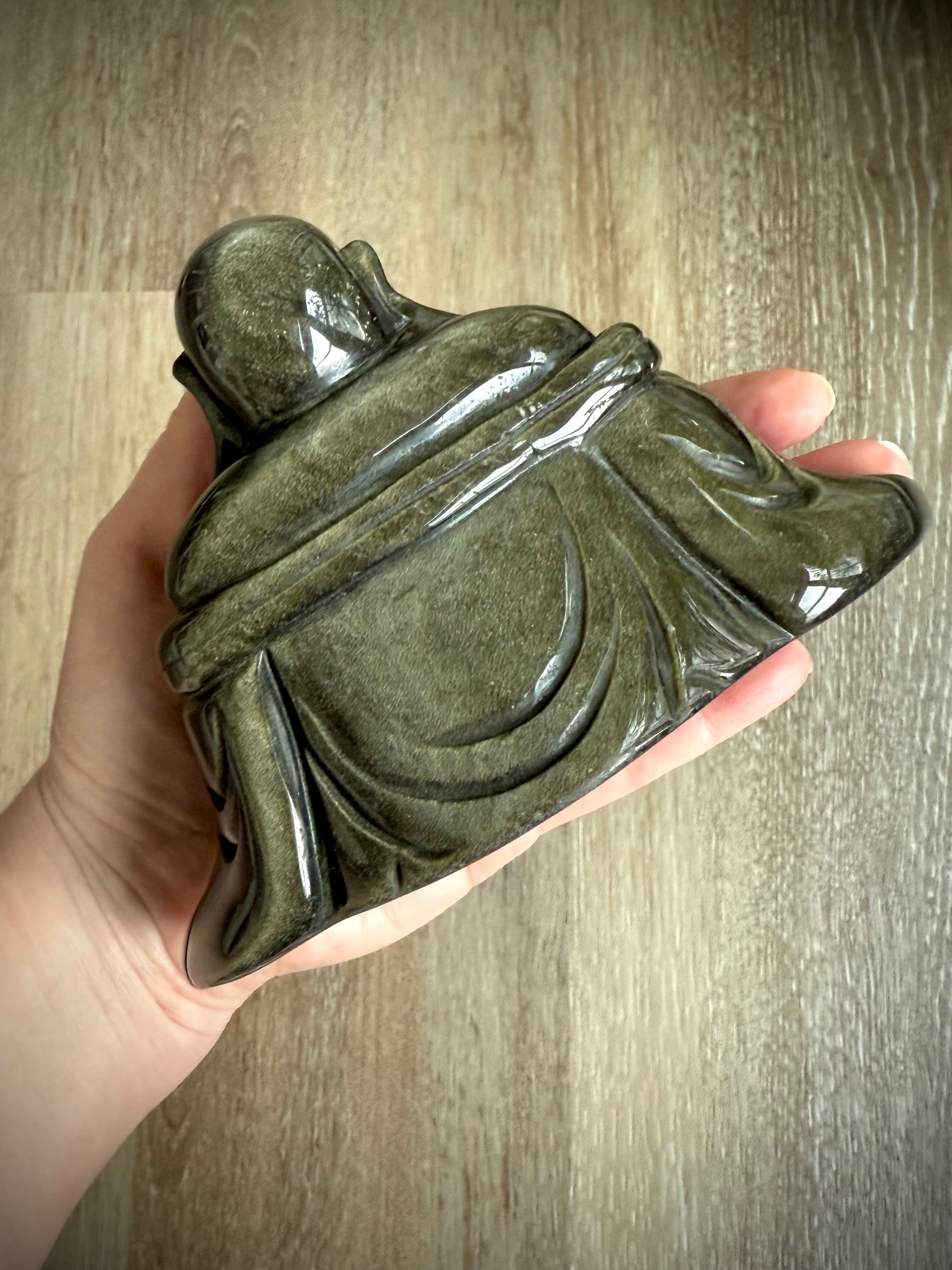 Back view of polished Golden Sheen Obsidian Buddha statue showing smooth robe details, crystal carving for grounding and spiritual energy