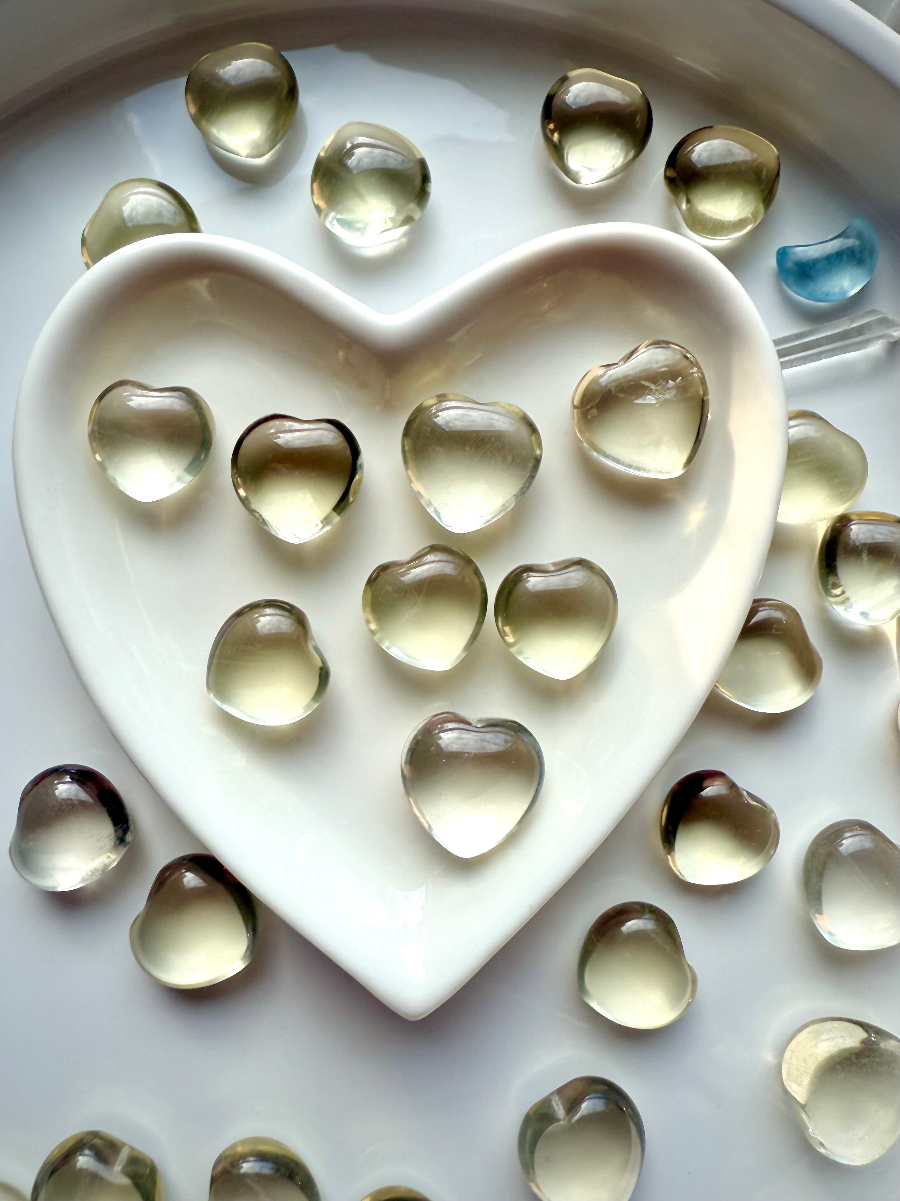 Mini Lemon Citrine heart crystals resting in a white heart bowl, uplifting yellow gemstones for confidence, joy, and radiant Solar Plexus energy