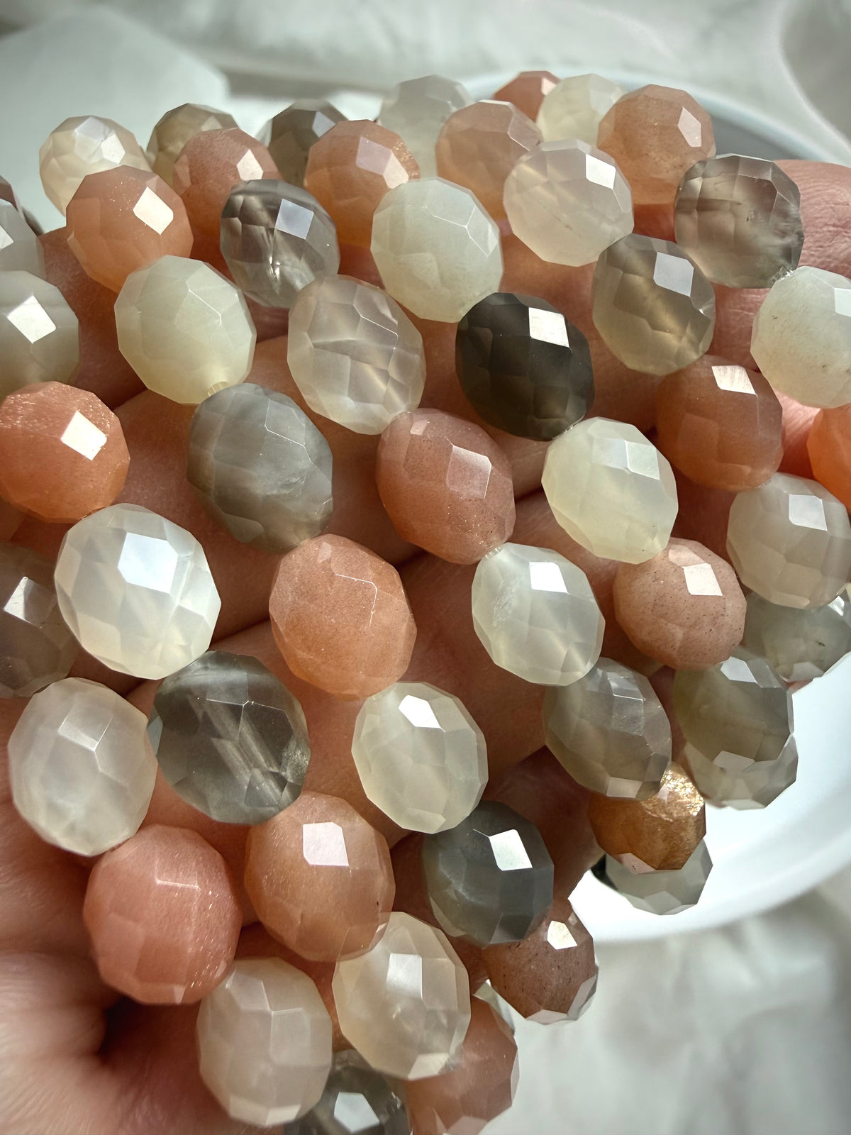 Natural Moonstone bracelet beads showing sparkling facets, silky shimmer, and beautiful variations in color and translucency