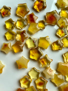 Polished Mini Amber Star crystals in golden honey tones for Solar Plexus chakra support