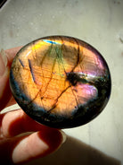 Labradorite palm stone with intense golden rainbow flash accented by green, blue, pink and purple labradorescence