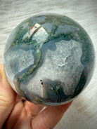 Dendritic Moss Agate crystal ball with sweeping green moss inclusions, gray chalcedony banding and polished finish