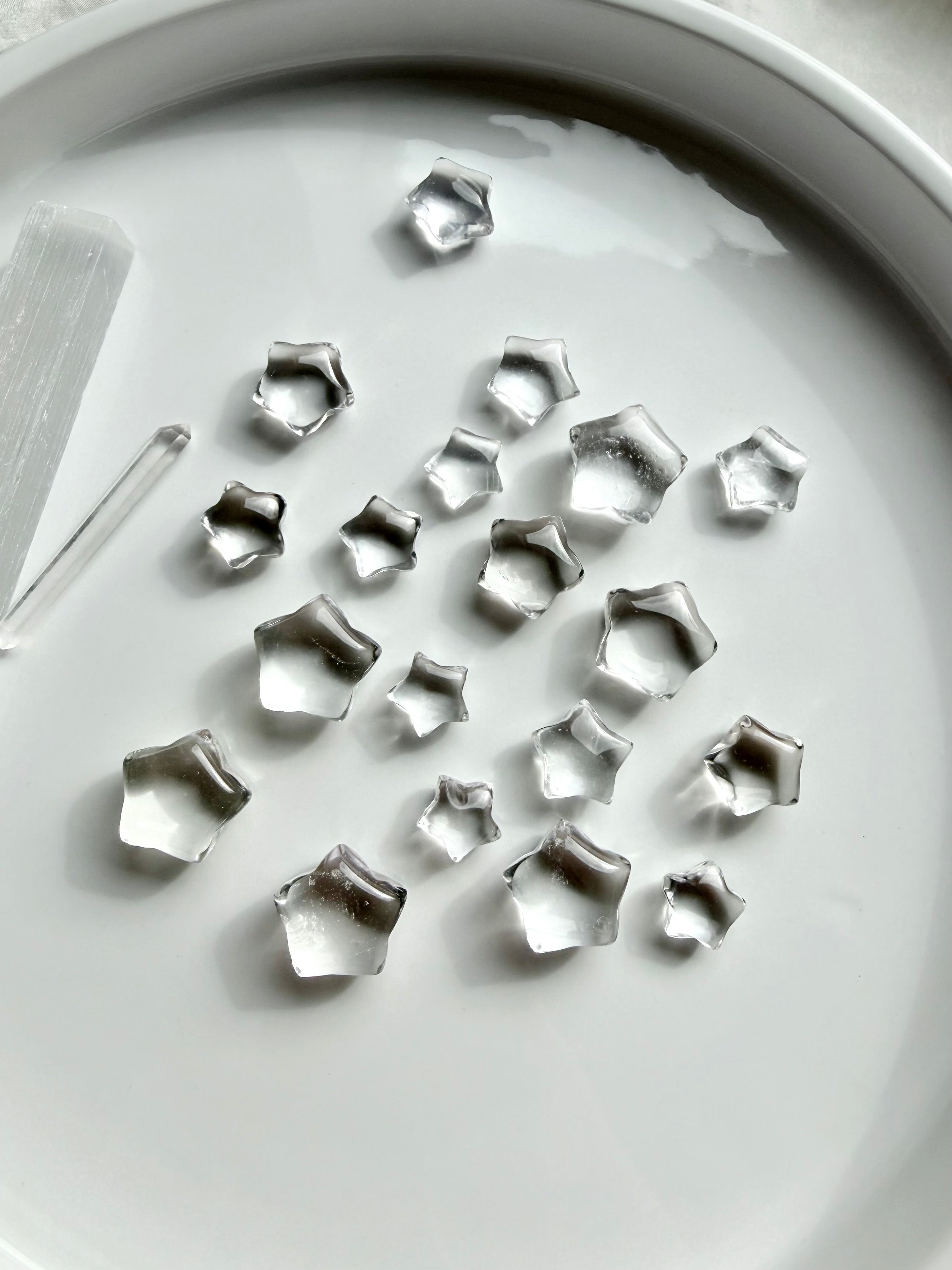 Mini Clear Quartz star carvings featuring sparkling transparent crystals, tiny five-point stars for clarity, manifestation and crystal grids