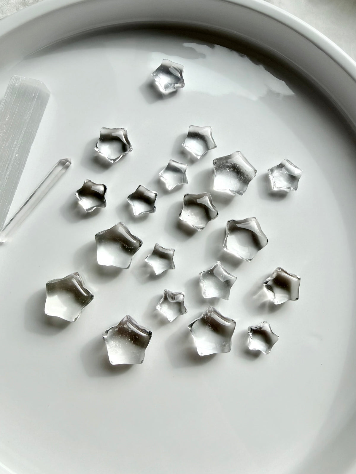Mini Clear Quartz star carvings featuring sparkling transparent crystals, tiny five-point stars for clarity, manifestation and crystal grids