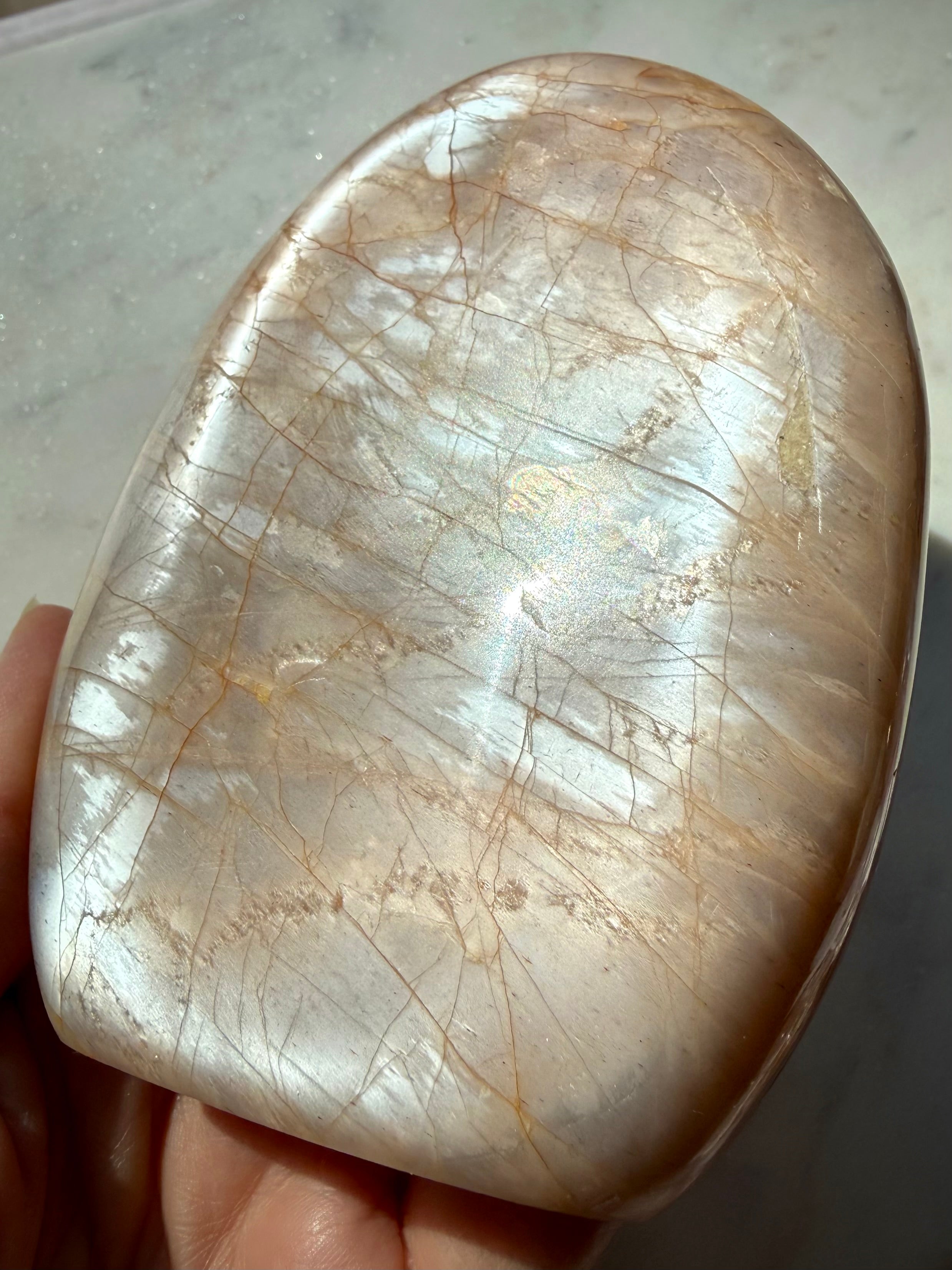 Peach Moonstone freeform showing angle-dependent silver flash and warm peach tones, a Sacral Chakra crystal