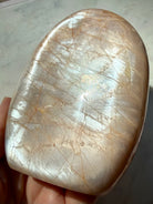 Peach Moonstone freeform showing angle-dependent silver flash and warm peach tones, a Sacral Chakra crystal