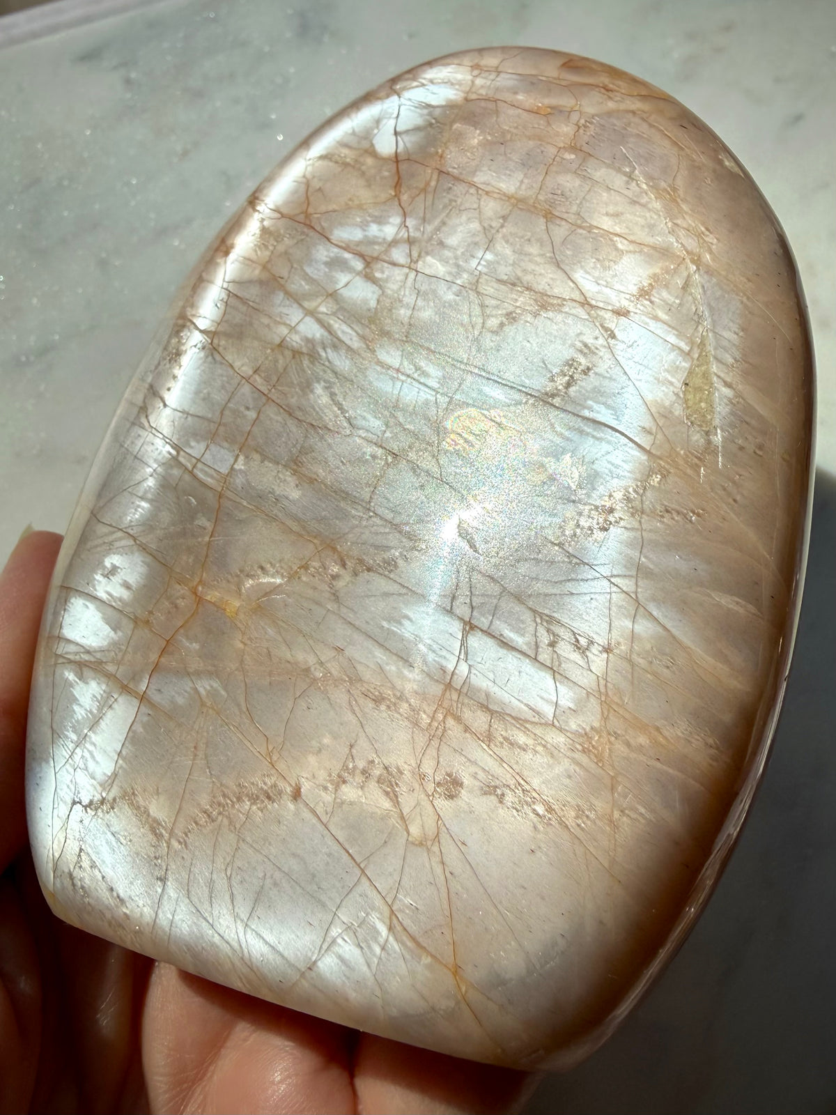 Peach Moonstone freeform showing angle-dependent silver flash and warm peach tones, a Sacral Chakra crystal