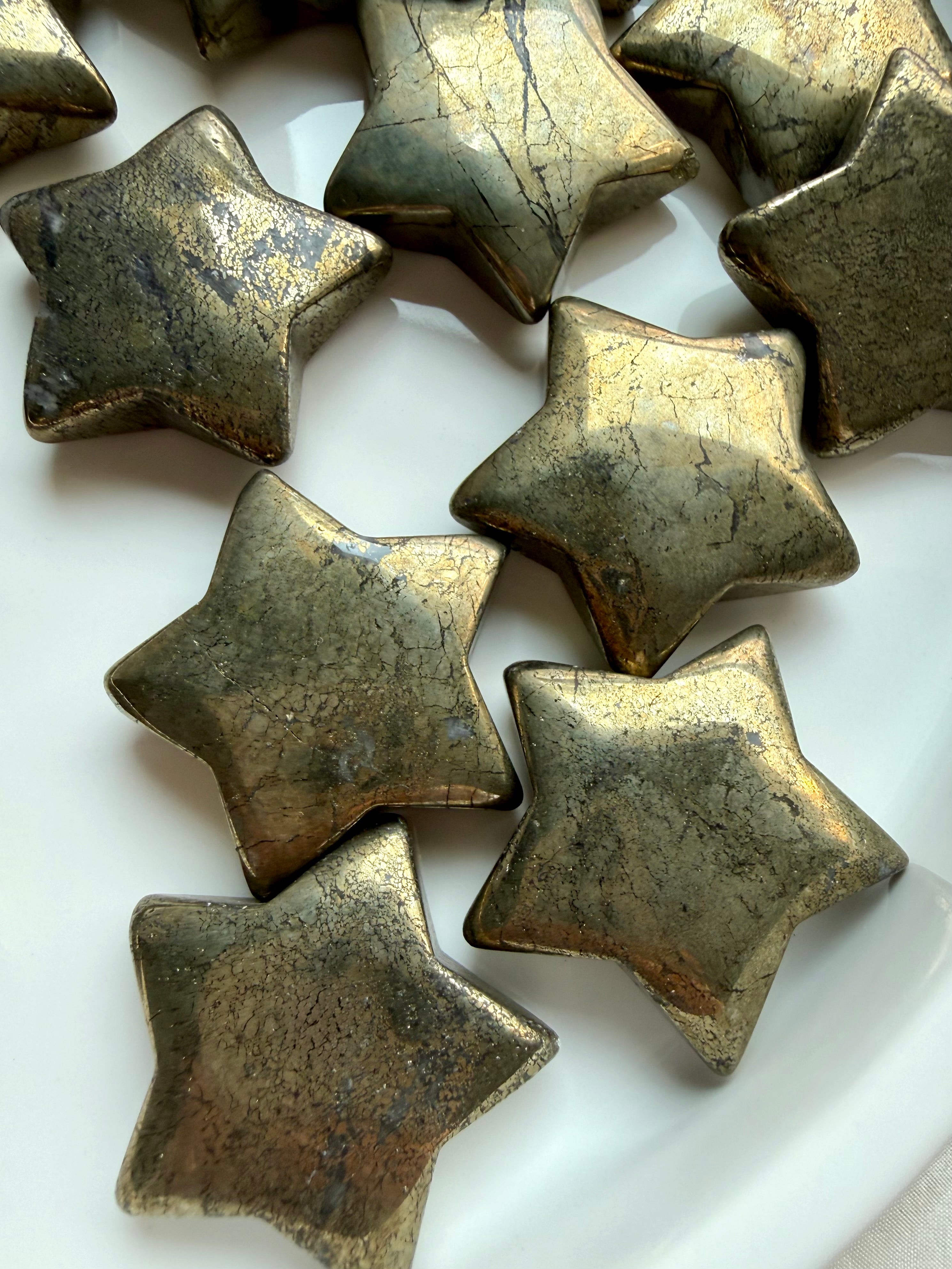 Pyrite crystal stars with shimmering metallic gold surfaces for confidence, motivation and success