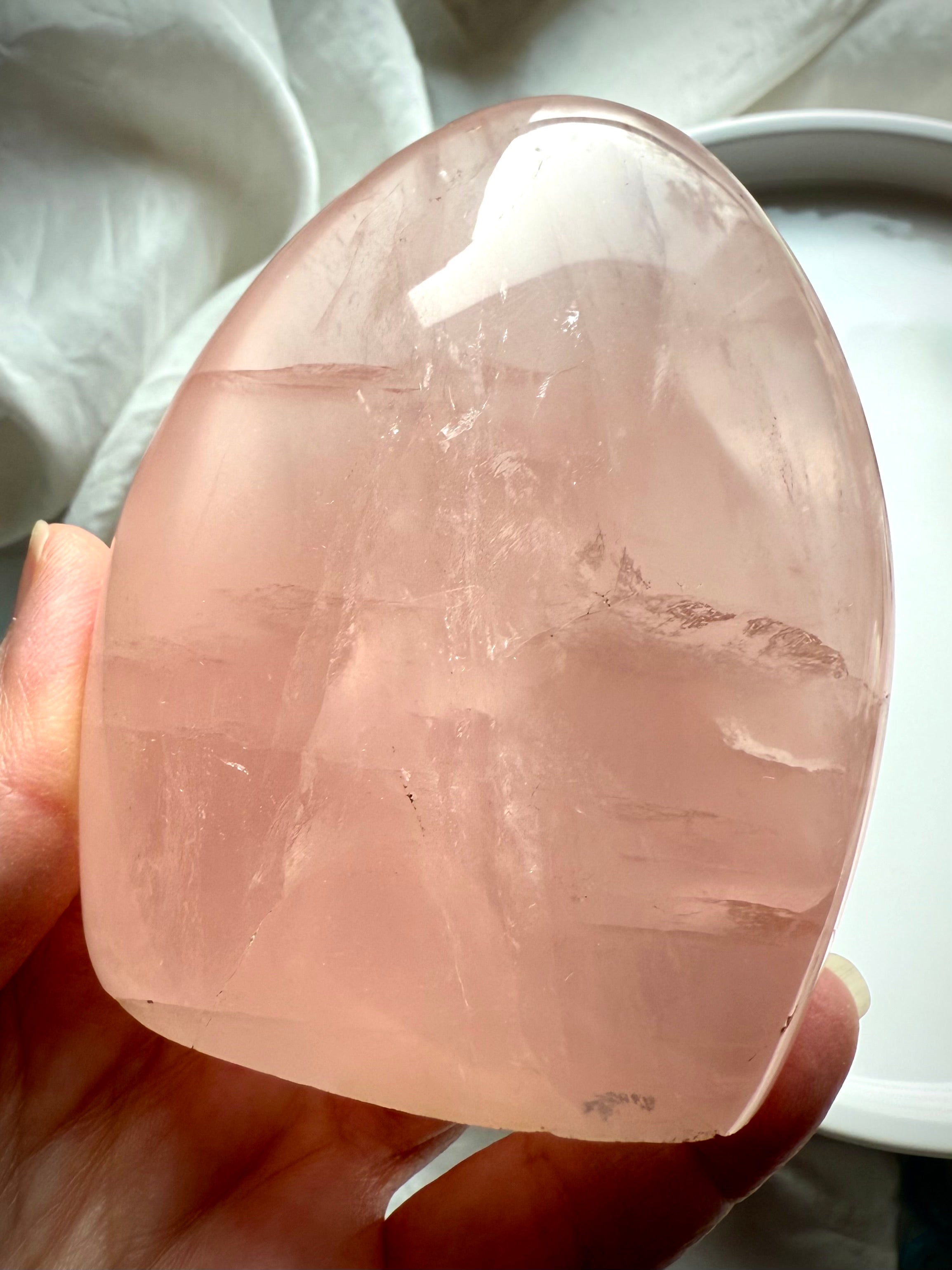 Luminous Rose Quartz freeform with transparent blush pink crystal and elegant sculptural display shape