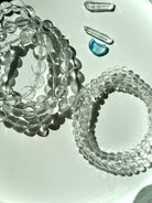 Clear Quartz bracelets with transparent crystal beads with exceptional natural clarity photographed in bright sunlight
