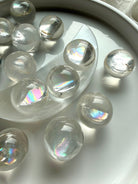 Rainbow girasol quartz mini sphere with silvery rainbow sheen under natural light, high-vibration meditation crystal