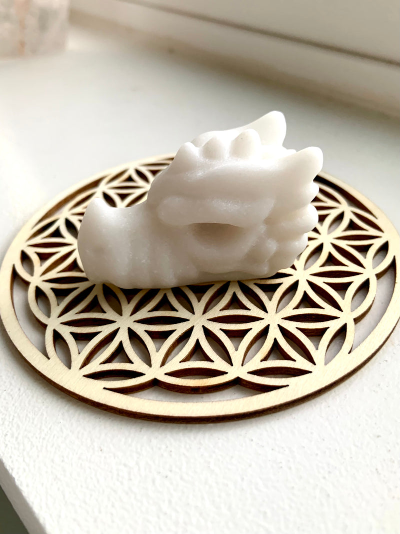 Mini White Jade Snow Dragon photographed on a Flower of Life crystal grid plate (optional)