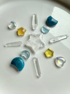 Mini aura quartz hearts arranged in a crystal grid with blue apatite moons, amber stars, and Lemurian points for angelic energy and light