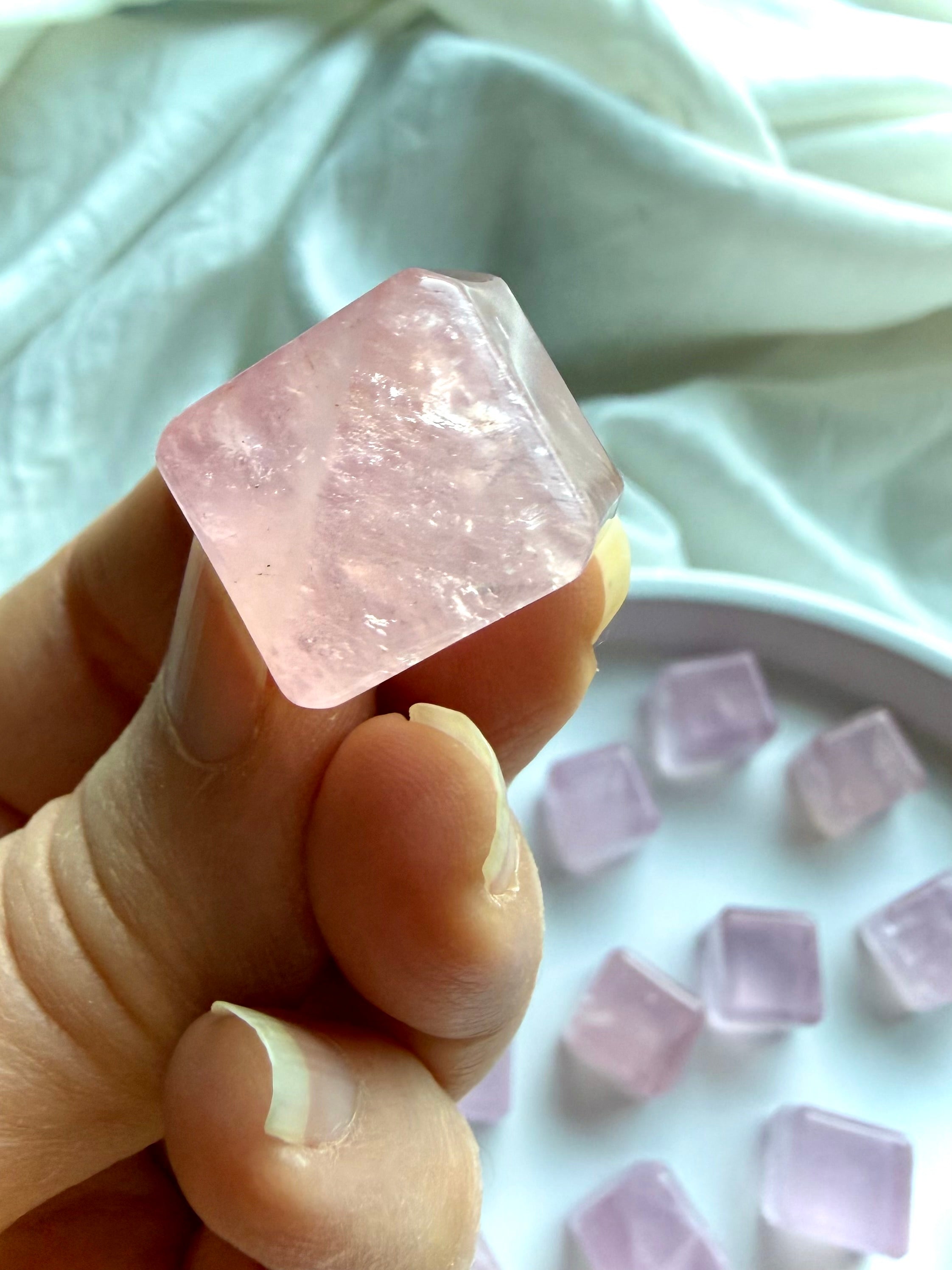 Rose quartz cube crystal with slightly irregular geometry and polished beveled edges, high quality heart chakra stone