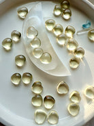 Mini Lemon Citrine heart crystals arranged in a selenite moon bowl, polished yellow citrine hearts for joy, confidence, and Solar Plexus Chakra healing