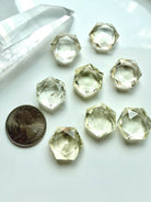 Mini Citrine hexagons beside a coin showing the size of these faceted sacred geometry crystals