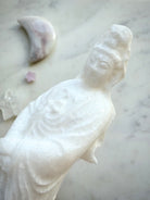 Detailed view of White Jade Goddess of Mercy carving with soft sparkle and elegant drapery